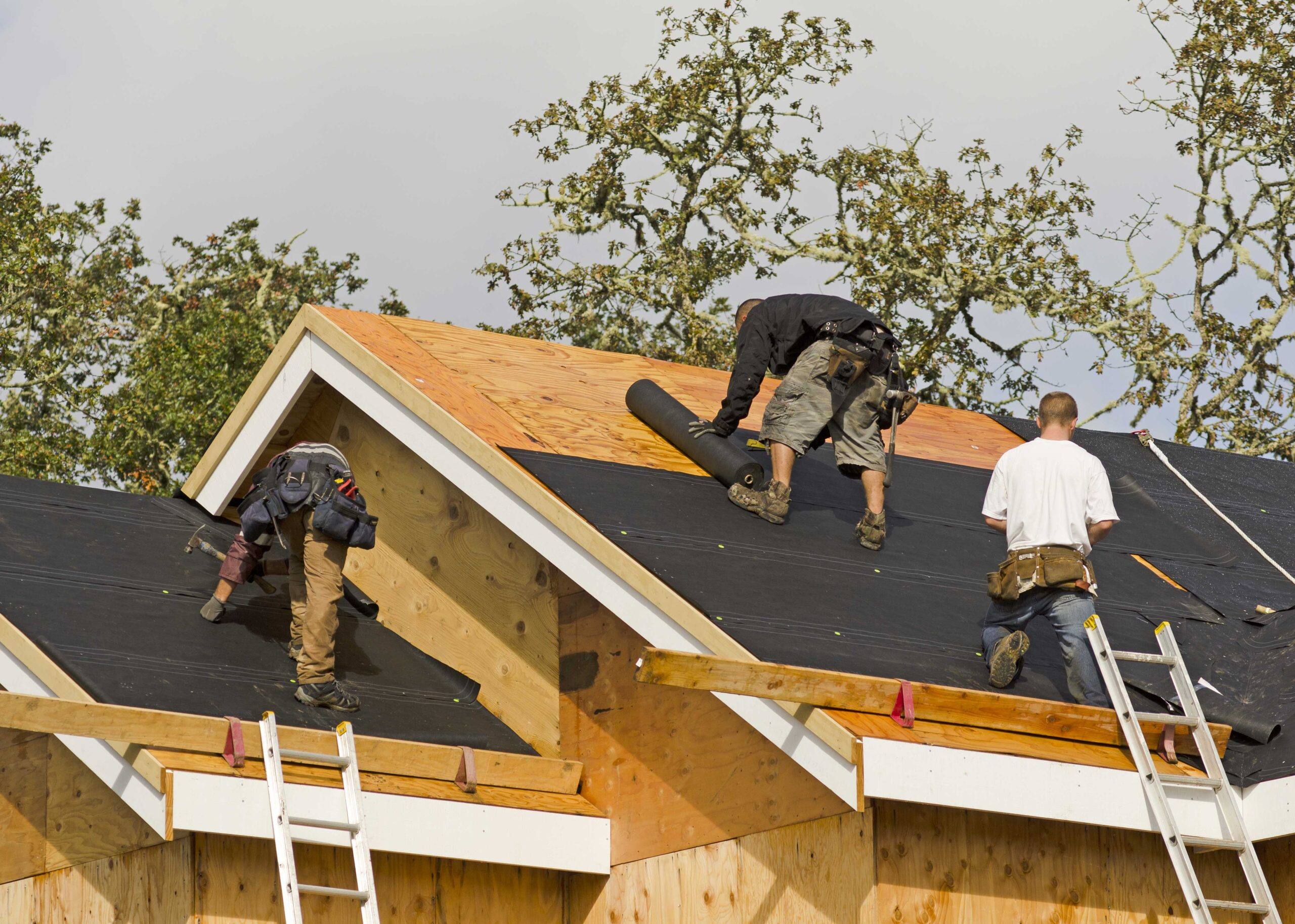 Roof repair experts working on a residential home.